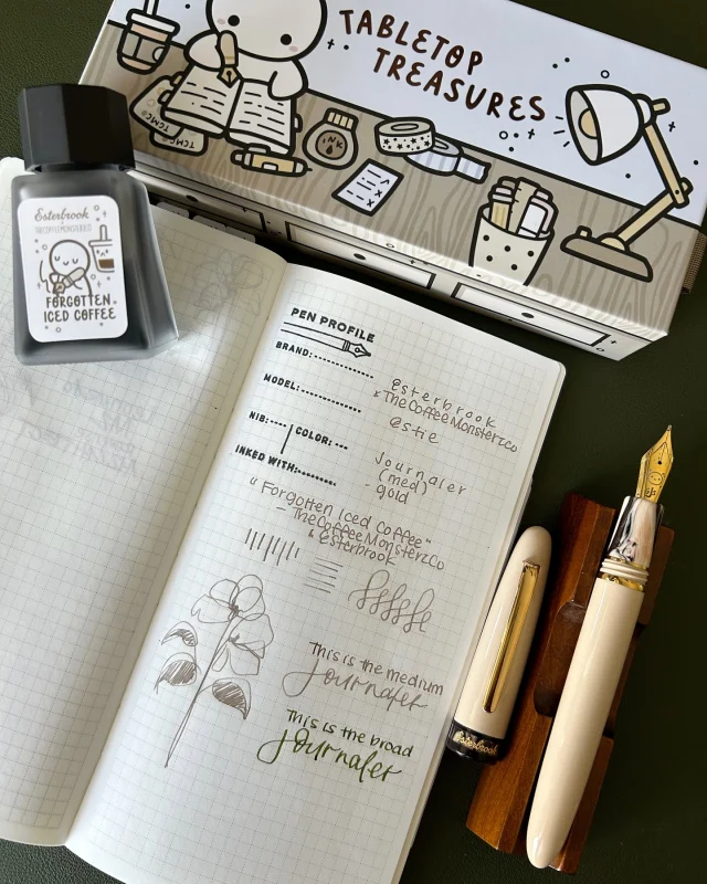Hi friends, hope you have a gentle end to the week 🫶🏽  Up on the channel: a closer look at the @esterbrook_official x @thecoffeemonsterzco Estie, matching ink called “Forgotten Iced Coffee” and blotter paper set. I love that each pen is unique because of the gorgeous material by Jonathon Brooks @carolinapencompany  If you’re curious, I compared the Journaler nib from Esterbrook to a custom ground Broad Journaler nib (both ground by Gena @customnibstudio ) in the video.  I’m in love with this collab and I’m in awe of Helen - knowing how much thought and effort she and the Esterbrook team put into this project amazes me. 🖋️☕️💕  #thecoffeemonsterzco #esterbrook #esterbrookpens #fountainpen #fountainpenink #fountainpenart
