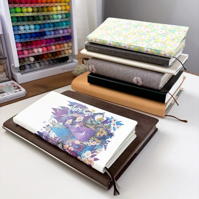 Mid-year planner and journal update 📚  Here’s what I’m using at the end of June:
1. PLOTTER A5 (catch-all planner and rapid log journal)
2. Hobonichi Weeks (on-the-go planner)
3. Hobonichi Weeks with a TN standard insert for overflow (memory keeper)
4. Hobonichi A5 5-Year (archive)
5. Hobonichi A6 5-Year (“little joys” and drawing practice)
6. Sterling Ink N2 (hobbies journal)
7. Sterling Ink B6 notebook (stream-of-consciousness writing)  Going into Q3-4, I’m sticking to my lineup (for now) with a temporary planner change in July-August. These two months are an anomaly in my daily routine and I adjust my planners to reflect that. I’ll be using a Travelers Notebook (passport size) fo planning. 
Updates are on yt and substack if you’re interested - I also mentioned my thoughts on 2026 👀  #plannerstack #hobonichiplanner #hobonichiweeks #plotterusa #sterlingink #travelersnotebookpassport #travelersnotebooks #hobonichi5yeartecho #functionalplanner